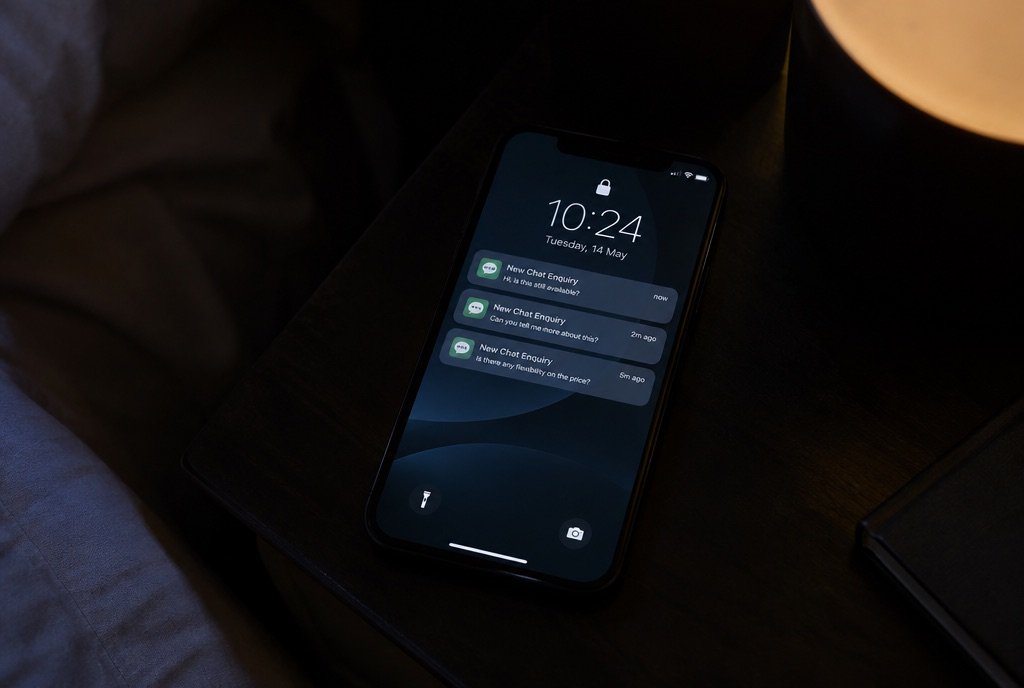 A phone lock screen showing three new WhatsApp enquiries at night